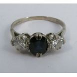 A sapphire and diamond three stone ring, set in 18ct white gold, 1979, the oval cut sapphire