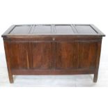 An Antique oak coffer, with four panel hinged top and front, width 56ins, depth 25.5ins, height
