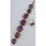 A bracelet, stamped 14k, set with seven oval cut colour change synthetic corundum stones, together