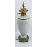 A 19th century French pâte-sur-pâte oil lamp, Paris or Limoges, decorated with white paste flower