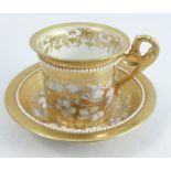 A 19th century Derby gold-ground cabinet cup and saucer, decorated with an applied band of pearls,