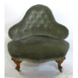 A Victorian upholstered arm chair, of triangular form with button back, raised on carved cabriole