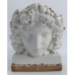 A tin-glazed pottery face mask, forming an architectural finial, representing Pomona or ‘Plenty’, by