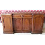 A 19th century mahogany breakfront sideboard, fitted with a drawer over a pair of cupboard doors