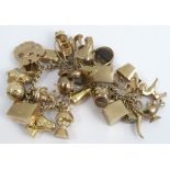 A 9 carat gold curb link bracelet, with 'padlock' clasp, numerous charms attached, 80g gross