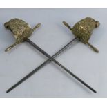 A pair of Alan Meek swords, with brass guard decorated with a crown, crosses and Classical motifs,