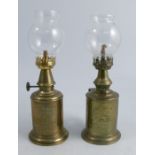 Two French brass oil lamps, Lampe Feutree Abeille and L'Hirondelle, both with glass shades