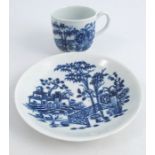 A First Period Worcester tea cup and saucer, decorated in the blue and white Fence