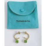 A pair of Tiffany & Co hoop earrings with peridot drops, stamped 'T&Co 750' to the wires and