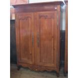 A Continental walnut inlaid armoire, fitted with doors and having inlaid star motif