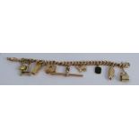 A 9 carat gold bracelet. of solid curb links, with eight charms attached, 42g gross