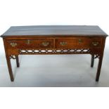 A George III oak dresser base, fitted with two drawers over a pierced frieze,  depth 18.5ins, length