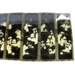 Eleven Oriental style rectangular black lacquer panels, decorated in mother of pearl and gilding