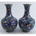 A pair of Cloisonne vases, decorated with foliage to a blue ground, height 8ins