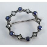 A diamond and synthetic sapphire circlet brooch, in unmarked white metal, 2.2cm diameter, 2.5g