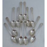 A set of twelve Scottish silver dessert spoons, with bright cut decoration and engraved with