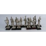 Fourteen metal figures, of various English regiments, raised on wooden plinths, height 4.75ins