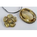 A large citrine Victorian pendant, the oval cut stone, approximately 42mm by 29mm by 4.4mm deep,