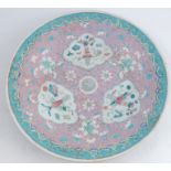 A Chinese shallow bowl, decorated in famille rose to a pink ground, af, diameter 14.5insCondition