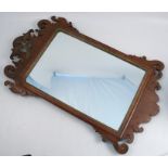 A 19th century mahogany framed fret cut wall mirror, decorated with a gilt HoHo bird, with