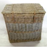 A wicker linen laundry basket, with hinged lid and leather straps, 29.5ins x 20ins x 30ins