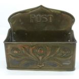 An Arts and Crafts brass Post holder, with embossed and pierced floral decoration, width 9ins,