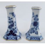A pair of 19th century Meissen candlesticks, decorated in the flowers and birds pattern in blue