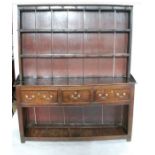 An Antique oak dresser, the rack with close boarded back, the base fitted with three frieze