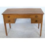 An Arts and Craft desk, of rectangular form, fitted with one long drawer and two smaller drawers,