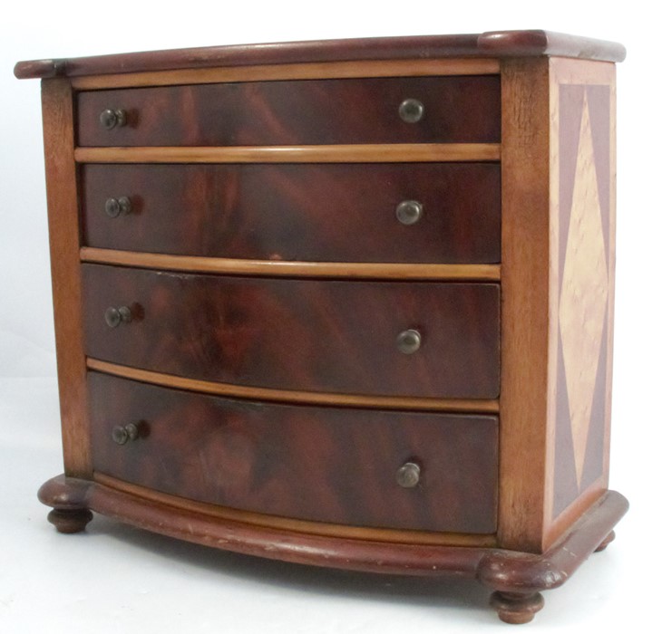 An apprentice piece mahogany chest, of four long graduating drawers, with a break bow front,