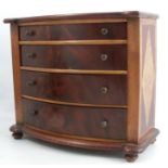 An apprentice piece mahogany chest, of four long graduating drawers, with a break bow front,