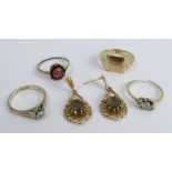 A signet ring, stamped '9ct'; three other rings; and a pair of 9 carat gold drop earrings