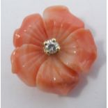 A carved coral flower head pendant, set in 18 carat, Birmingham 1976, centred with a brilliant cut