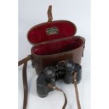 A pair of Negretti & Zambra London cased binoculars, marked Valkyron x7 30m/m 777759