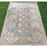 An Eastern design rug, decorated with triangular lozenges to the pale ground, 48ins x 77ins