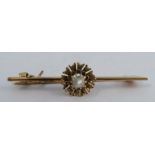A bar brooch, set with a diamond octahedra crystal, 4cm long, 2.5g gross