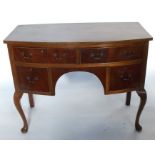 A mahogany bow front dressing table, fitted two short over two drawers, raised on cabriole legs,