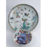 A Chinese shallow bowl, decorated with insects, foliage and bonsai, heavily restored, diameter 13.