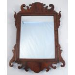 A 19th century mahogany framed fret cut wall mirror, with rectangular plate, plate size 10ins x 8ins