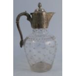 A silver and glass claret jug, the silver mount decorated with leaves, the handle with leaf
