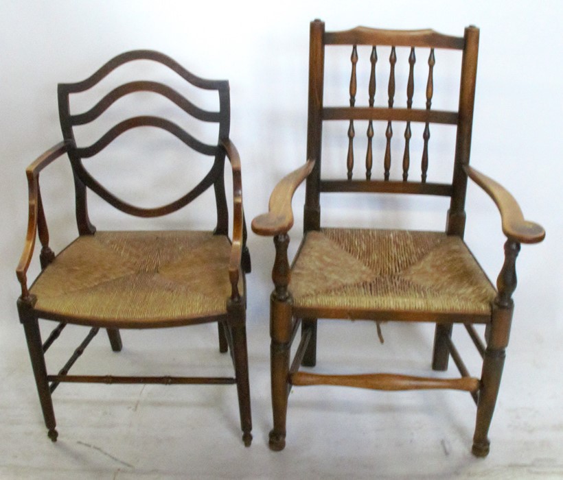 An Antique beech open arm chair, with shield shape back, having a rush seat with turned