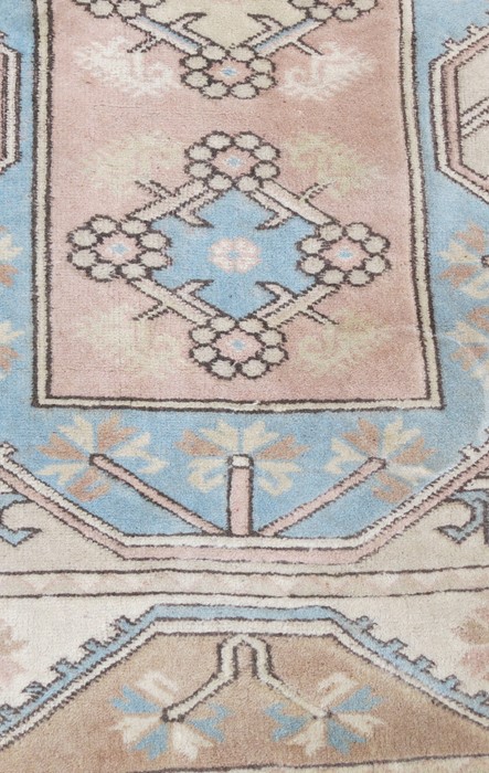 An Eastern design rug, decorated with triangular lozenges to the pale ground, 48ins x 77ins - Image 2 of 3