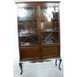 An Edwardian mahogany display cabinet, fitted with cupboard doors under the glazed doors, raised