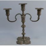 A silver candelabrum, with three scones and two branches, raised on a knopped stem, to a shaped