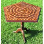 An oak tilt top table, the pentagon shaped top with parquetry inlay, raised on an octagonal baluster