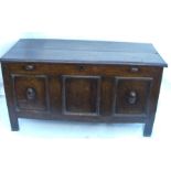 An Antique oak coffer, with two plank rising lid, the front with three fielded panels, width 53.