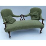 A Victorian upholstered showwood spoon back settee, with carved decorated to the back and arms,