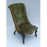 A 19th century rosewood nursing chair, with upholstered back and seat, showwood frame and raised