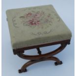 A 19th century mahogany stool, with tapestry seat raised on cross supports, 18ins x 18ins x 16ins