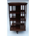 An Edwardian mahogany revolving book stand, or rectangular form, raised on a triform base, 24ins x